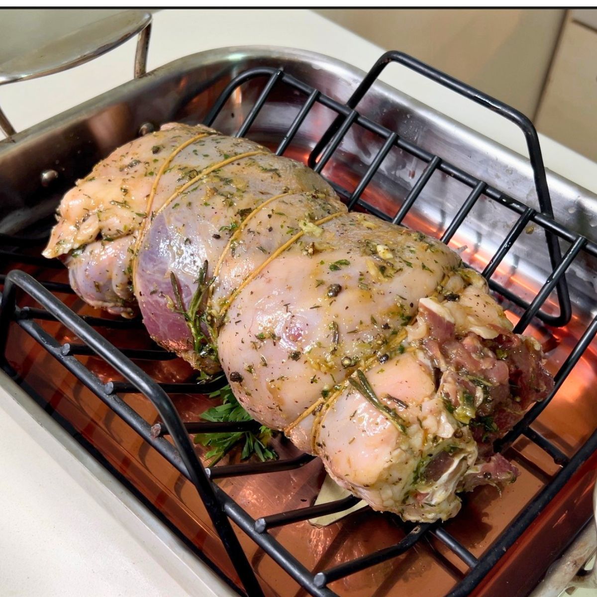 Place a roast lamb on a roasting rack.