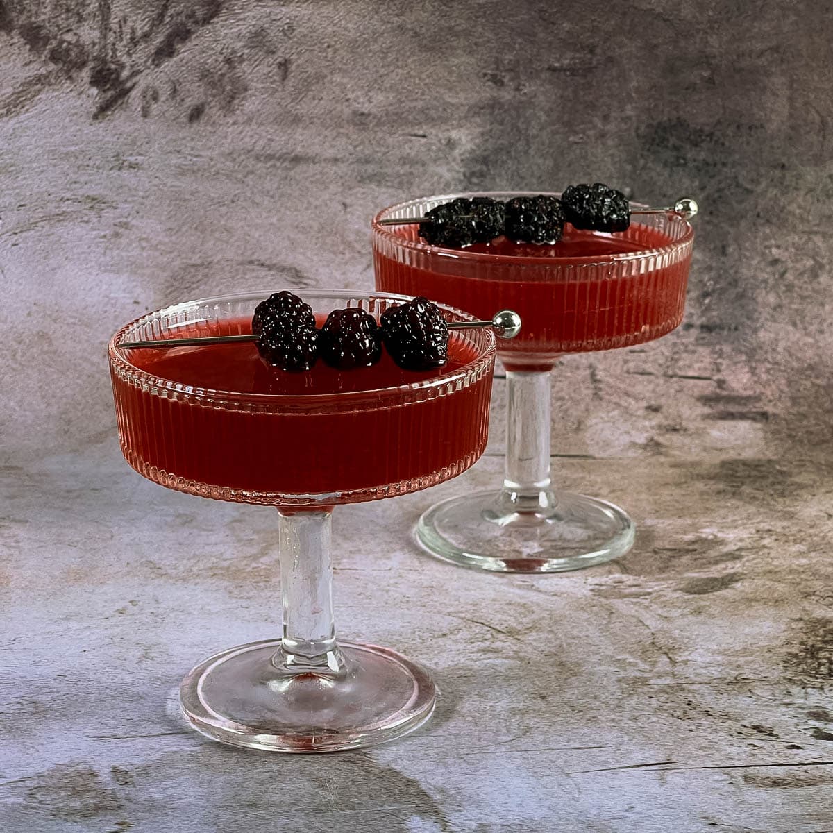 Two blackberry cocktails on the table.