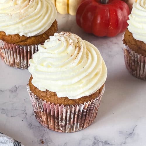 Frosted cupcakes on the table.
