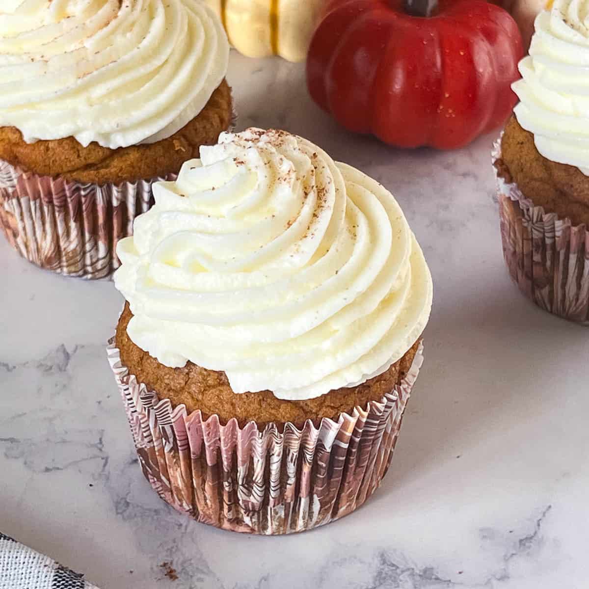 Frosted cupcakes on the table.