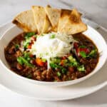 Taco soup in a white bowl.